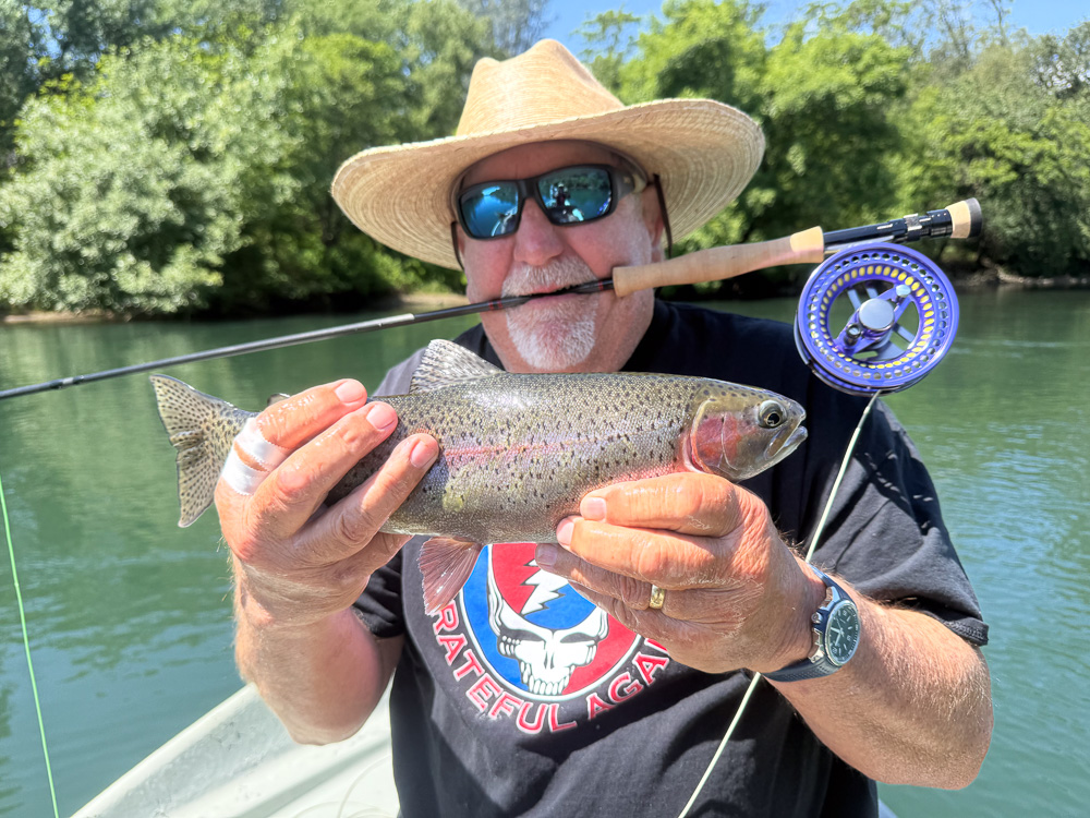 Man with trout and rod