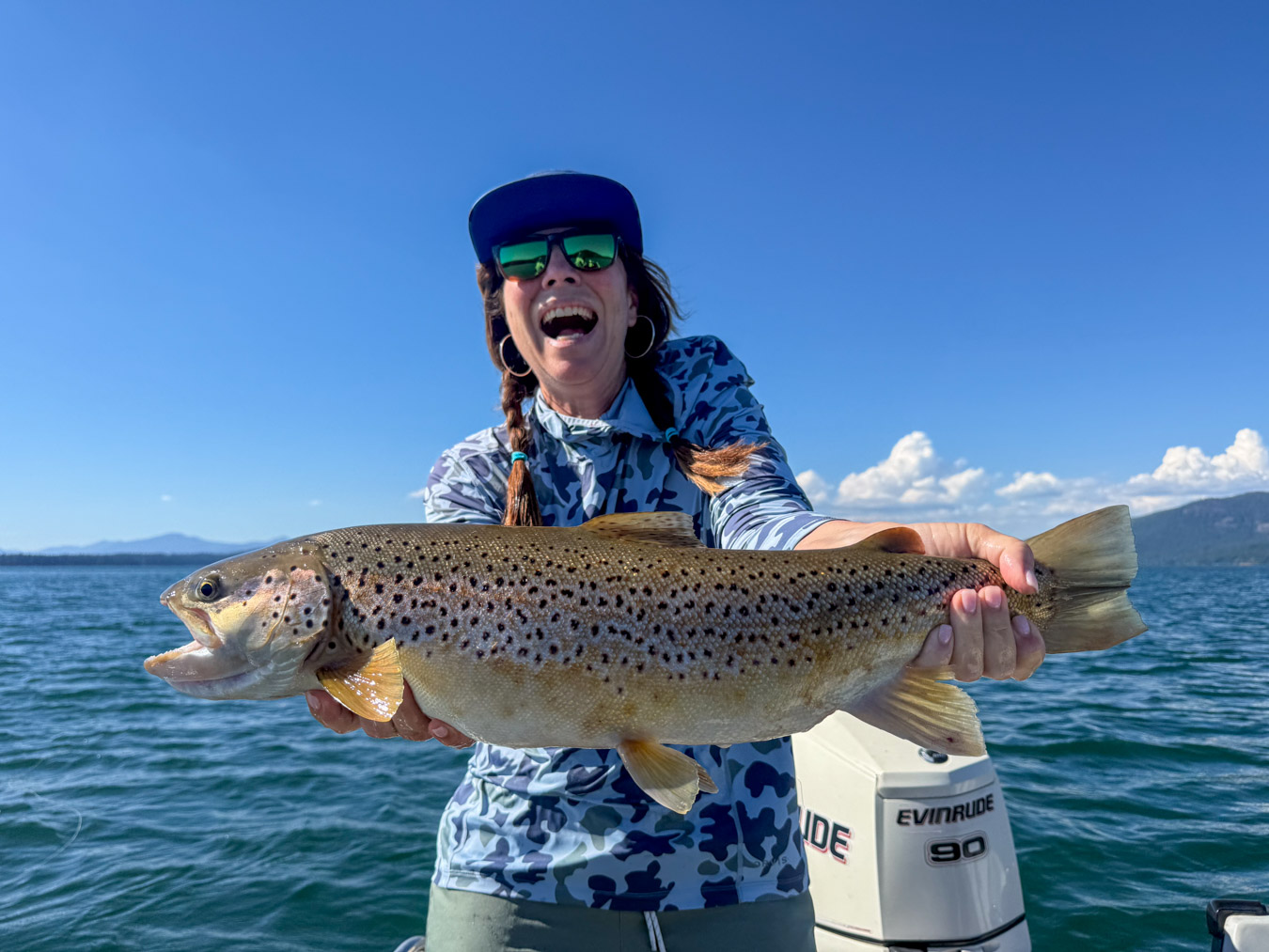 Woman holding a 26 inch brown trout at Lake Almanor during the hex hatch