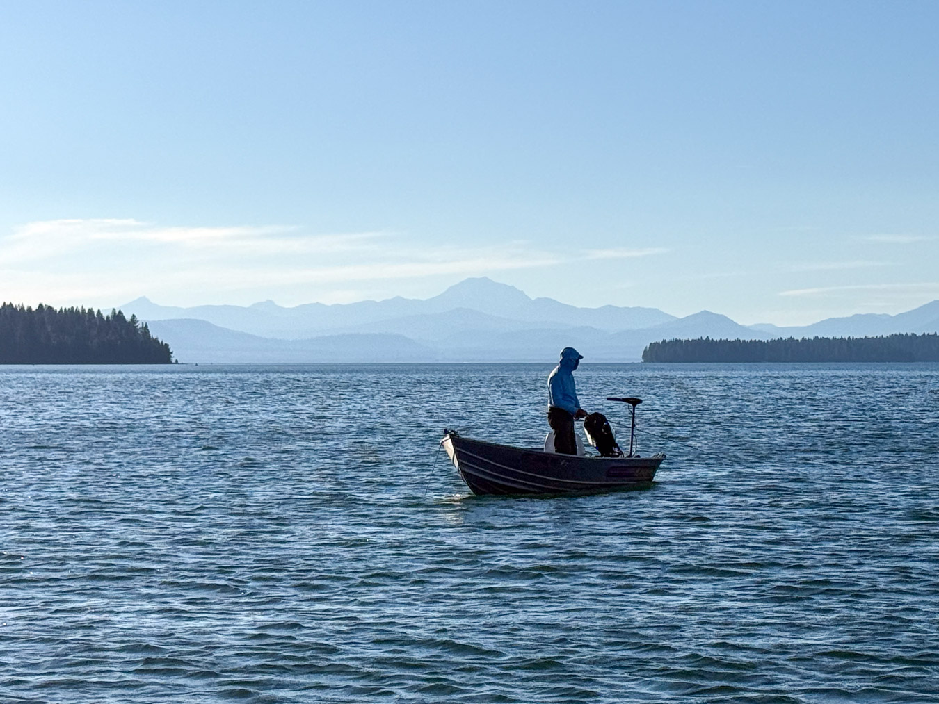 Man on a boat fishing lake almanor