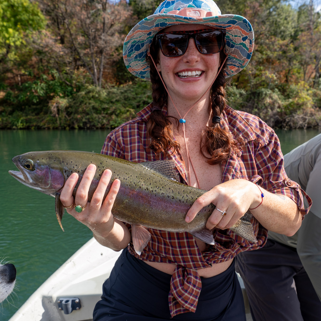 Woman holding a rainbow trout caught on the fly